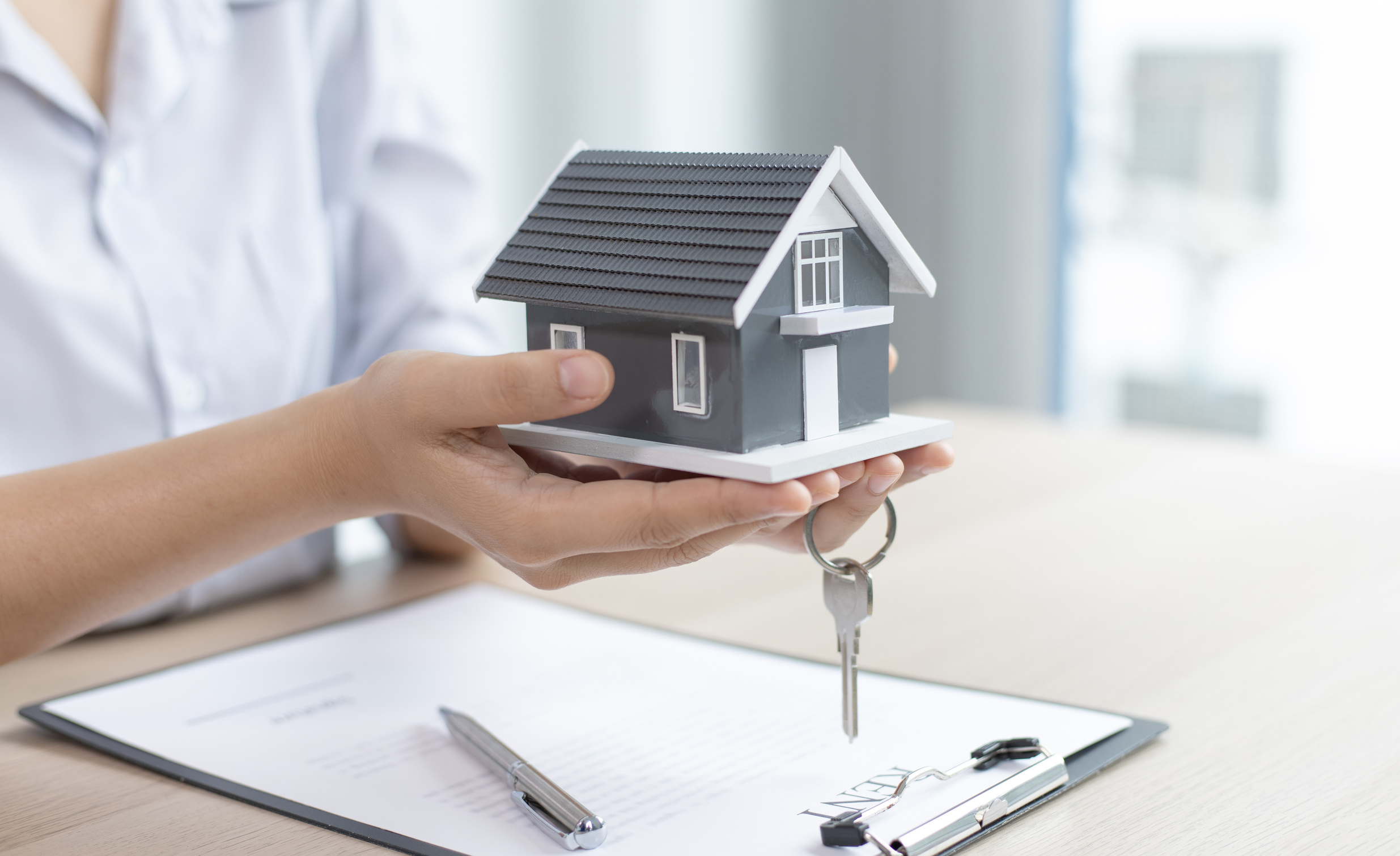 Real Estate Agent Awarding the House Key